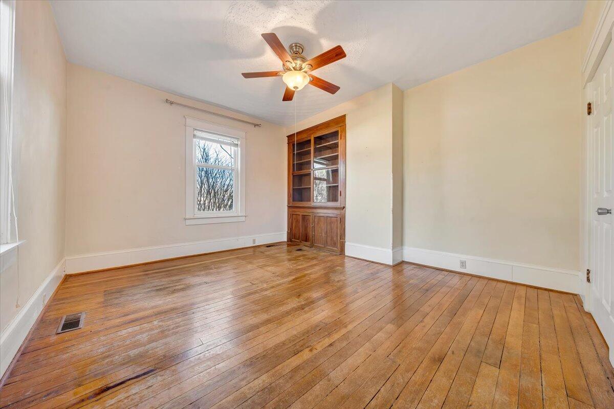 181 Chestnut Grove Road Callaway, VA 24067 - Photo 23 of 51 an empty room with wooden floor and windows
