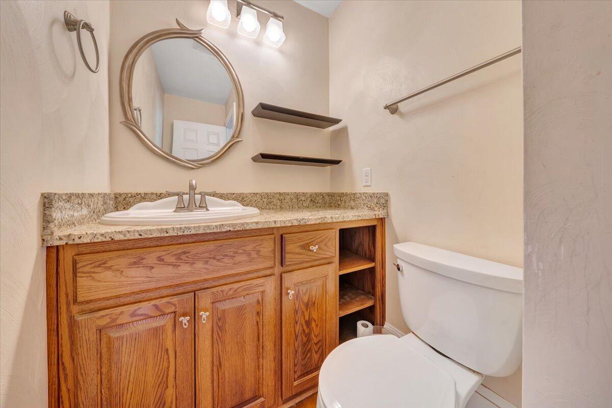 181 Chestnut Grove Road Callaway, VA 24067 - Photo 27 of 51 a bathroom with a granite countertop toilet sink and mirror