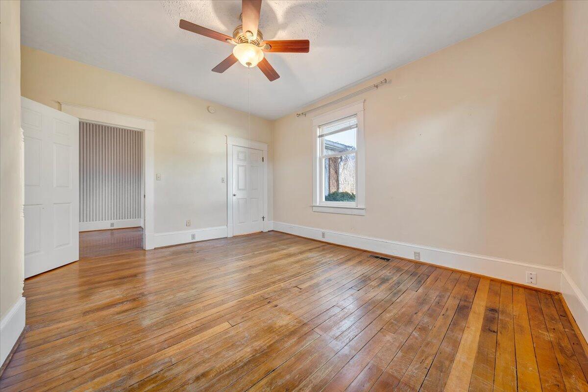 181 Chestnut Grove Road Callaway, VA 24067 - Photo 28 of 51 an empty room with wooden floor and windows
