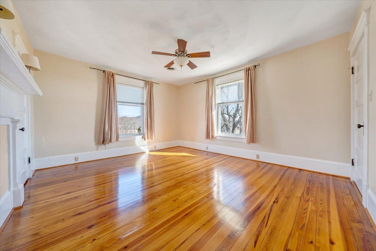 181 Chestnut Grove Road Callaway, VA 24067 - Photo 30 of 51 a view of empty room with wooden floor and fan