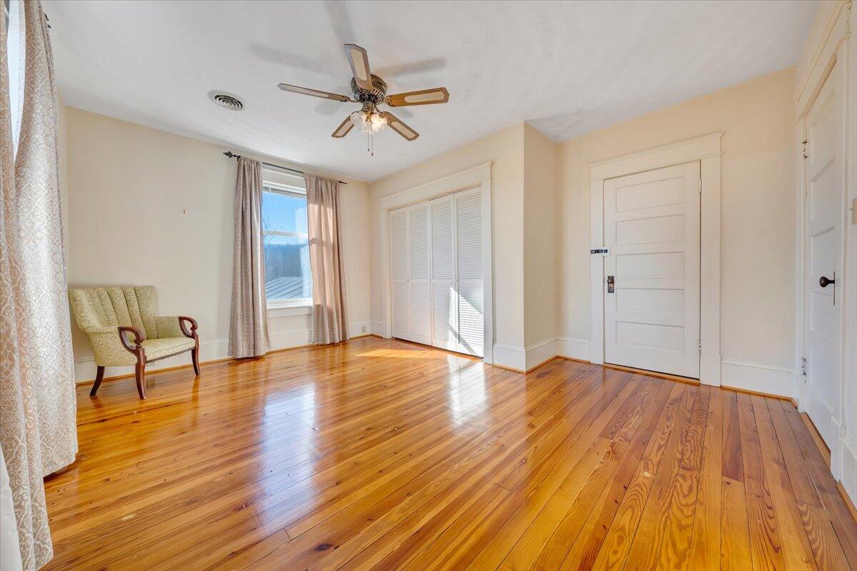 181 Chestnut Grove Road Callaway, VA 24067 - Photo 35 of 51 a view of empty room with wooden floor and fan