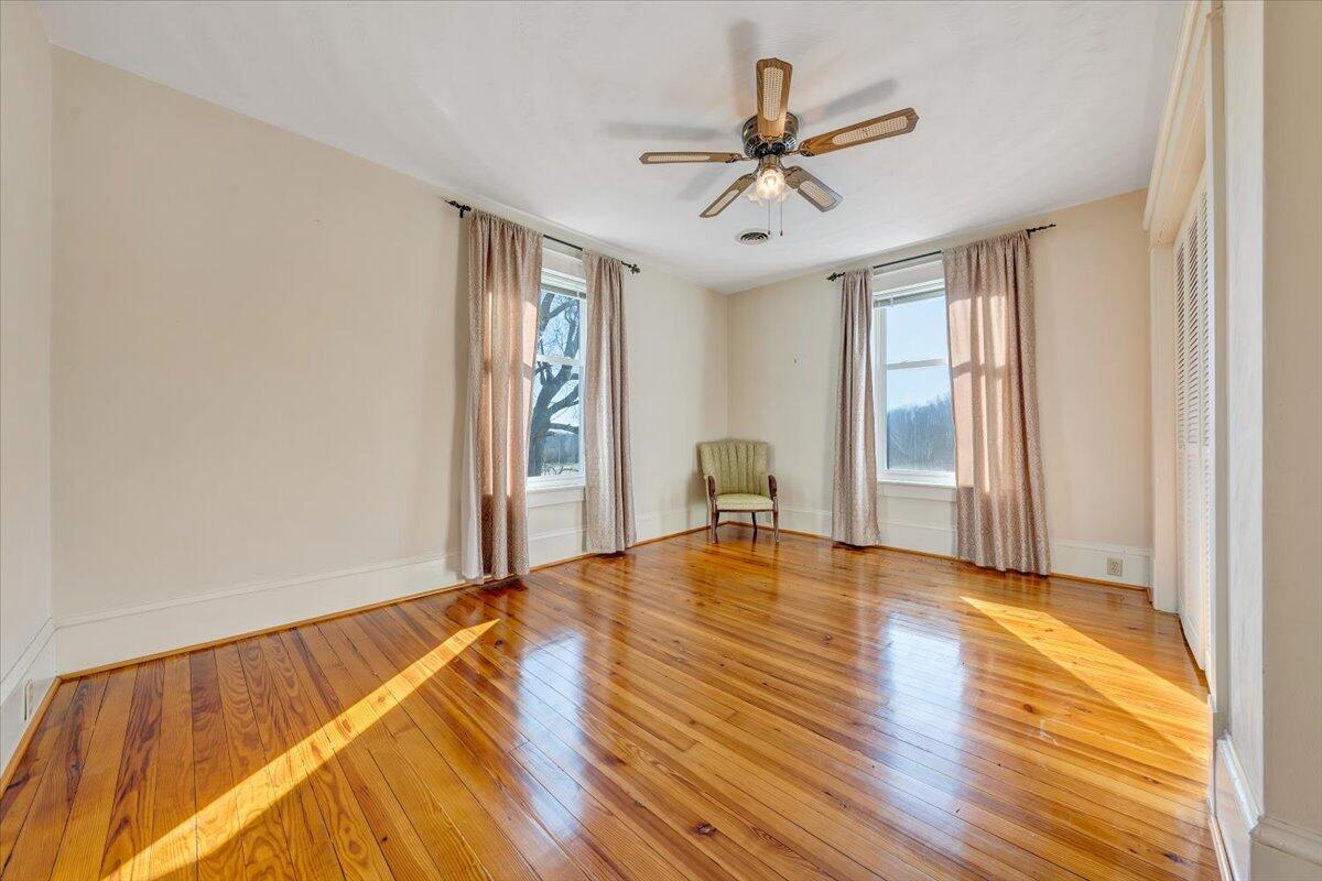 181 Chestnut Grove Road Callaway, VA 24067 - Photo 36 of 51 a view of empty room with wooden floor and fan