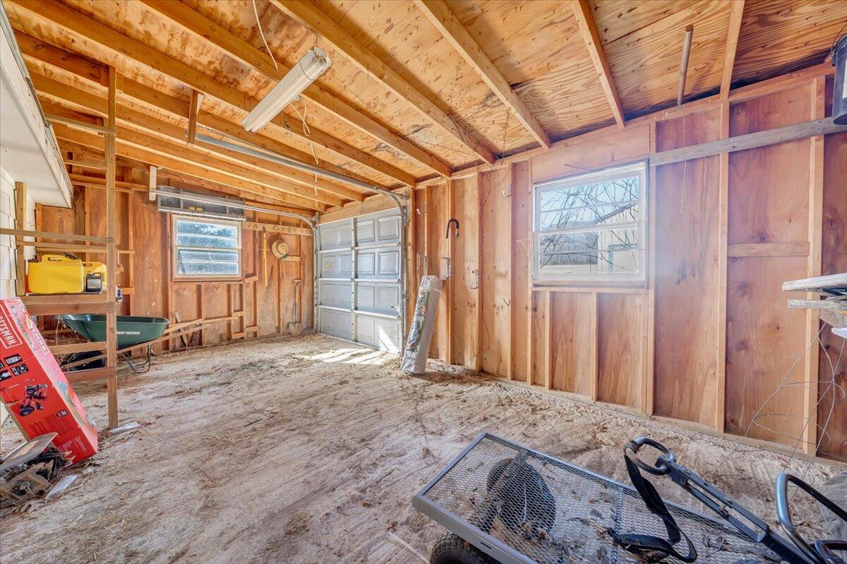 181 Chestnut Grove Road Callaway, VA 24067 - Photo 42 of 51 a bedroom with a bed a desk and large windows