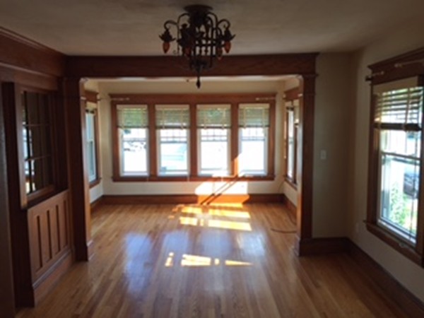 15-17 Windemere Street Springfield, MA 01104 - Photo 3 of 9 wooden floor in an empty room with a window