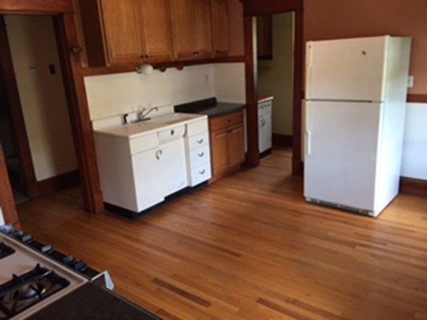 15-17 Windemere Street Springfield, MA 01104 - Photo 5 of 9 a kitchen with a refrigerator a stove and wooden floor
