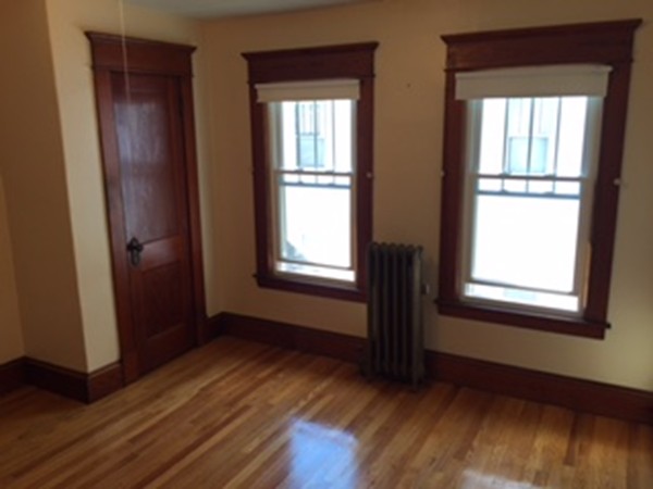 15-17 Windemere Street Springfield, MA 01104 - Photo 7 of 9 an empty room with wooden floor and windows