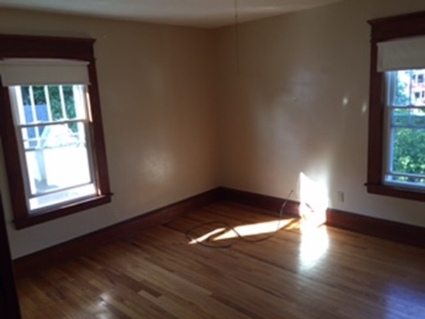 15-17 Windemere Street Springfield, MA 01104 - Photo 8 of 9 an empty room with wooden floor and windows