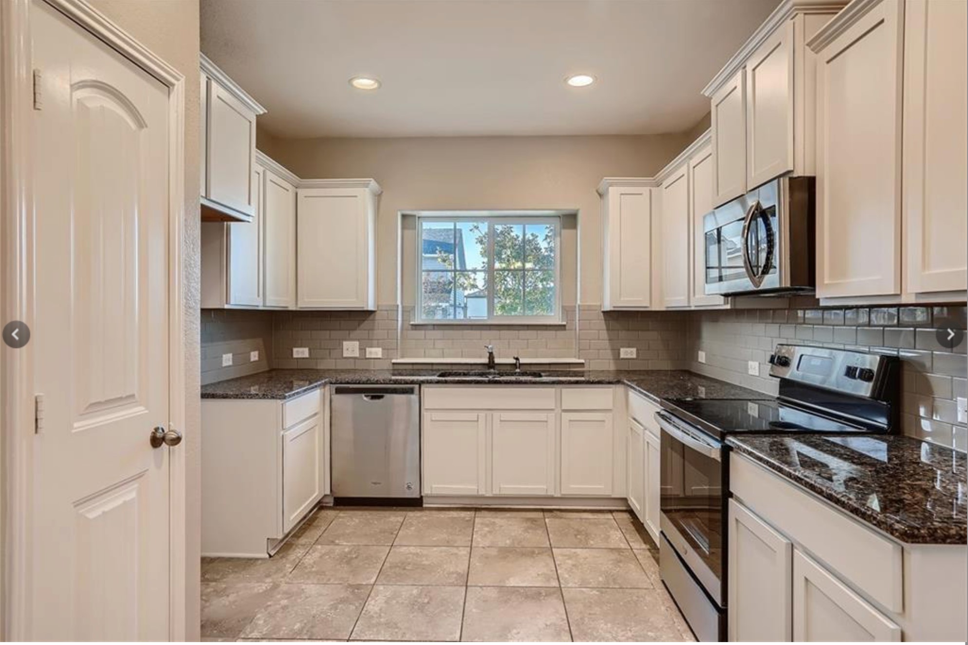 304 Cane River Road Pflugerville, TX 78660 - Photo 4 of 31 A well-equipped kitchen features sleek stainless steel appliances, ample white cabinetry, and durable granite countertops.