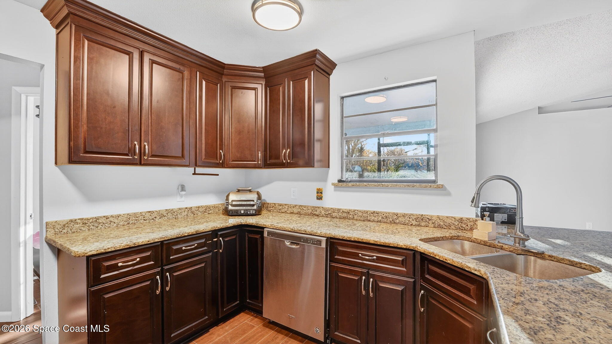6398 Cable Avenue Cocoa, FL 32927 - Photo 11 of 30 a kitchen with granite countertop a sink stove and cabinets