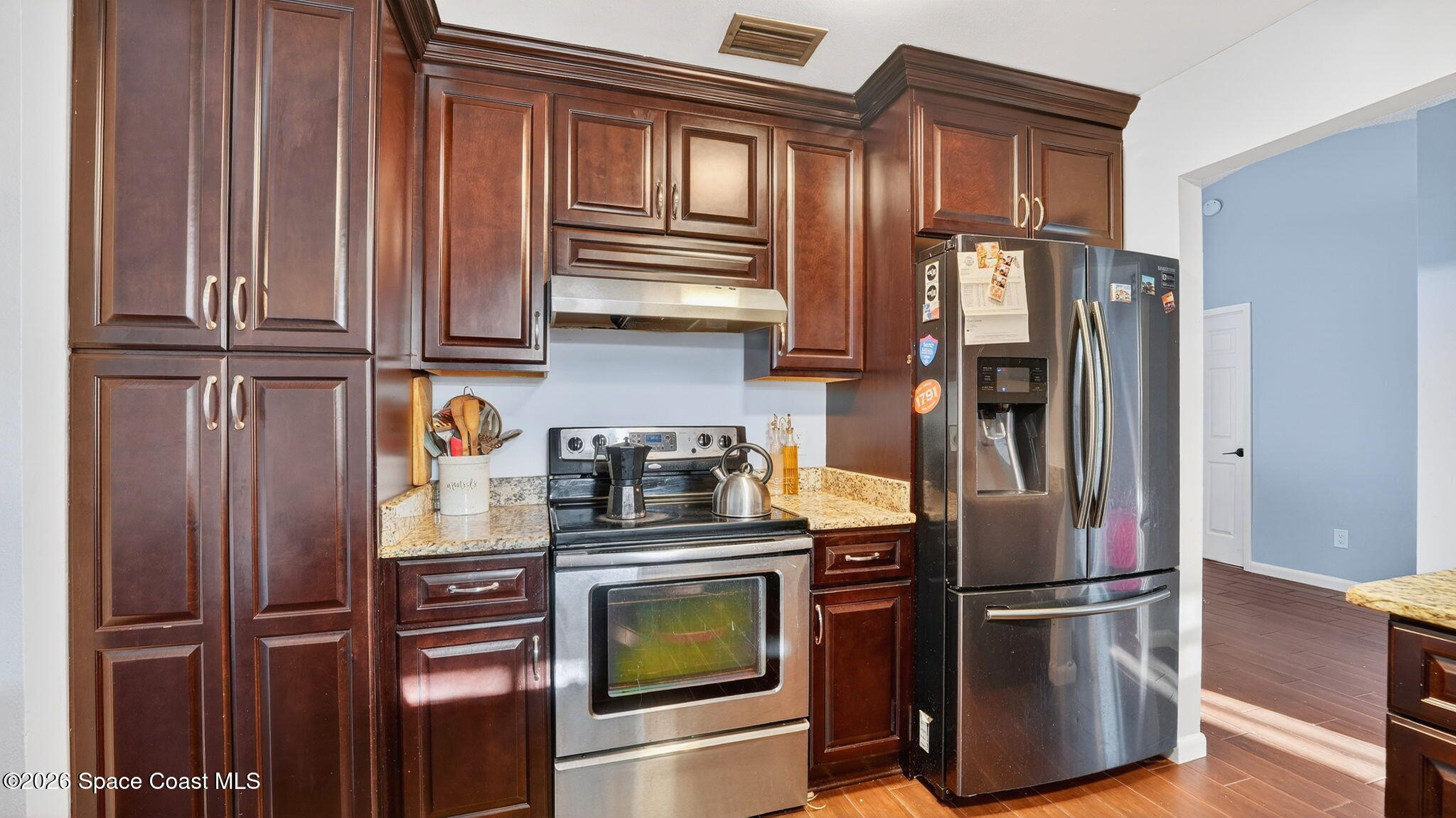 6398 Cable Avenue Cocoa, FL 32927 - Photo 14 of 30 a kitchen with stainless steel appliances granite countertop a refrigerator and microwave