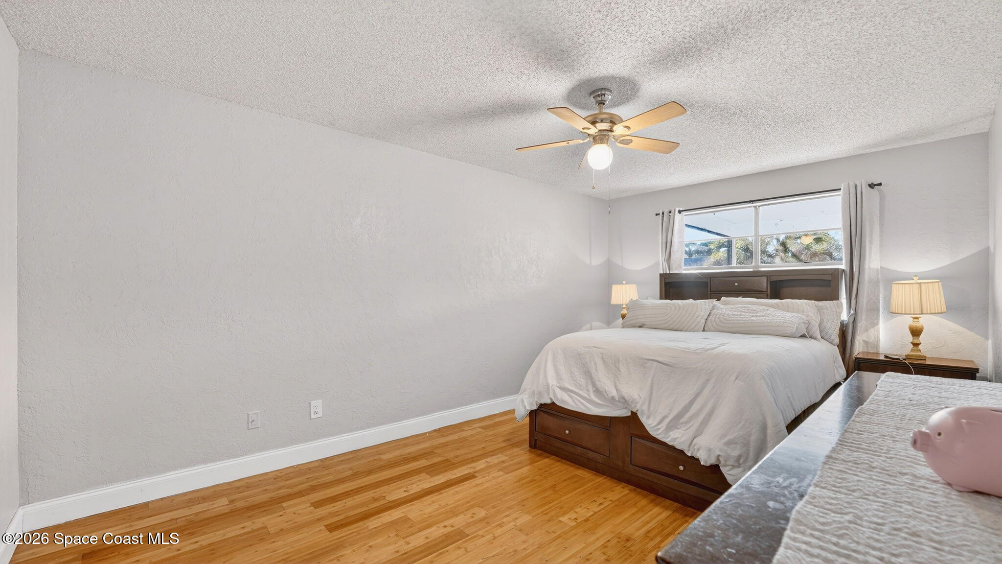 6398 Cable Avenue Cocoa, FL 32927 - Photo 17 of 30 a spacious bedroom with a bed and a chandelier