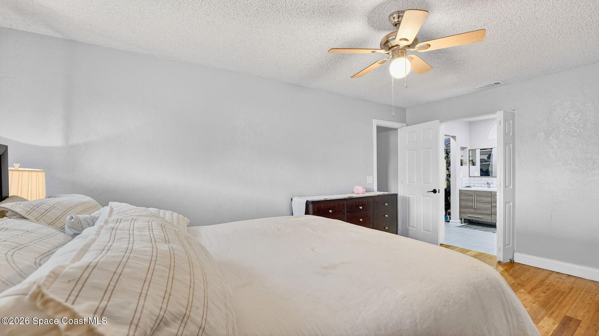 6398 Cable Avenue Cocoa, FL 32927 - Photo 18 of 30 a bedroom with a bed and a chandelier