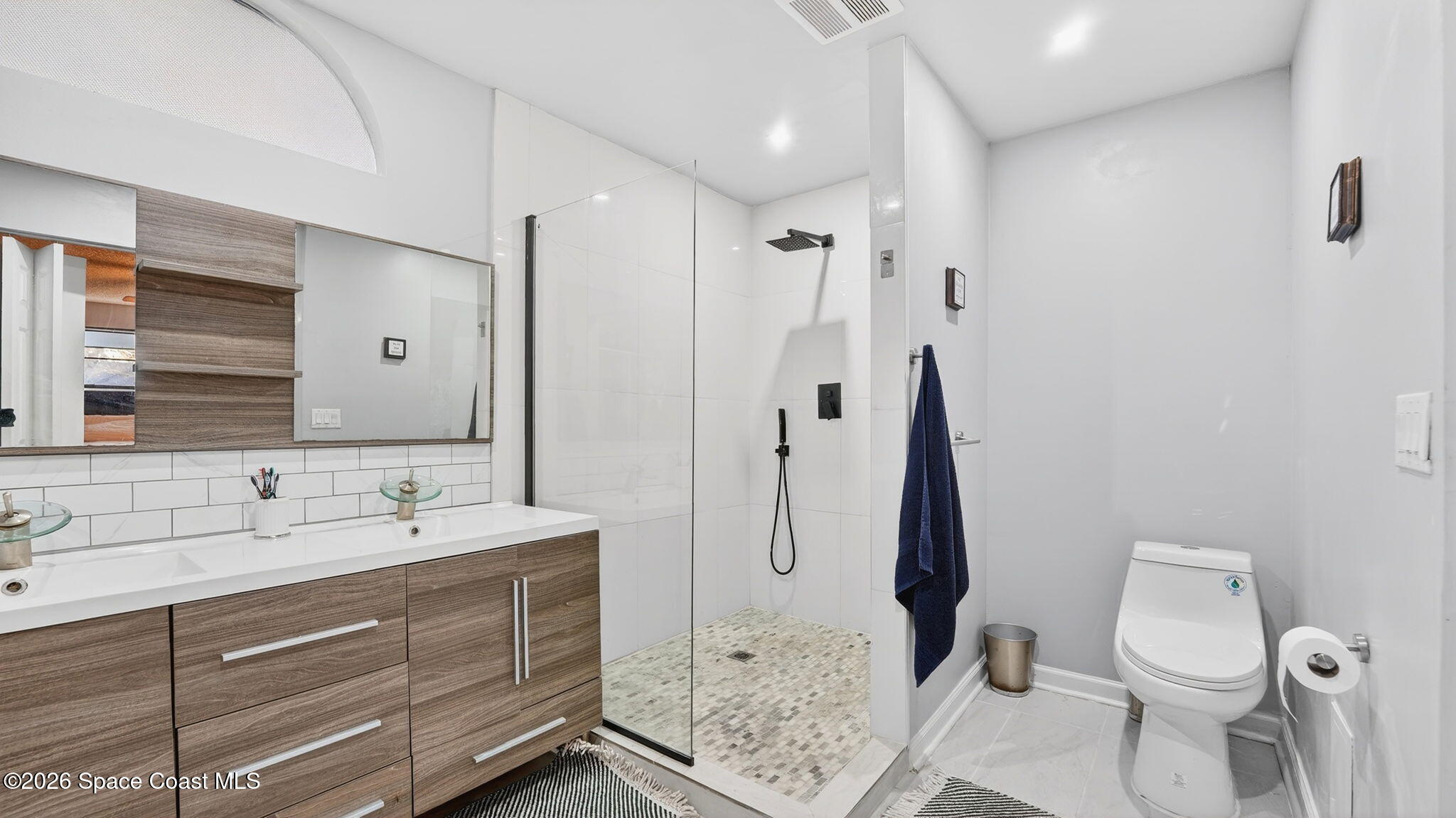 6398 Cable Avenue Cocoa, FL 32927 - Photo 19 of 30 a bathroom with a sink a toilet and shower