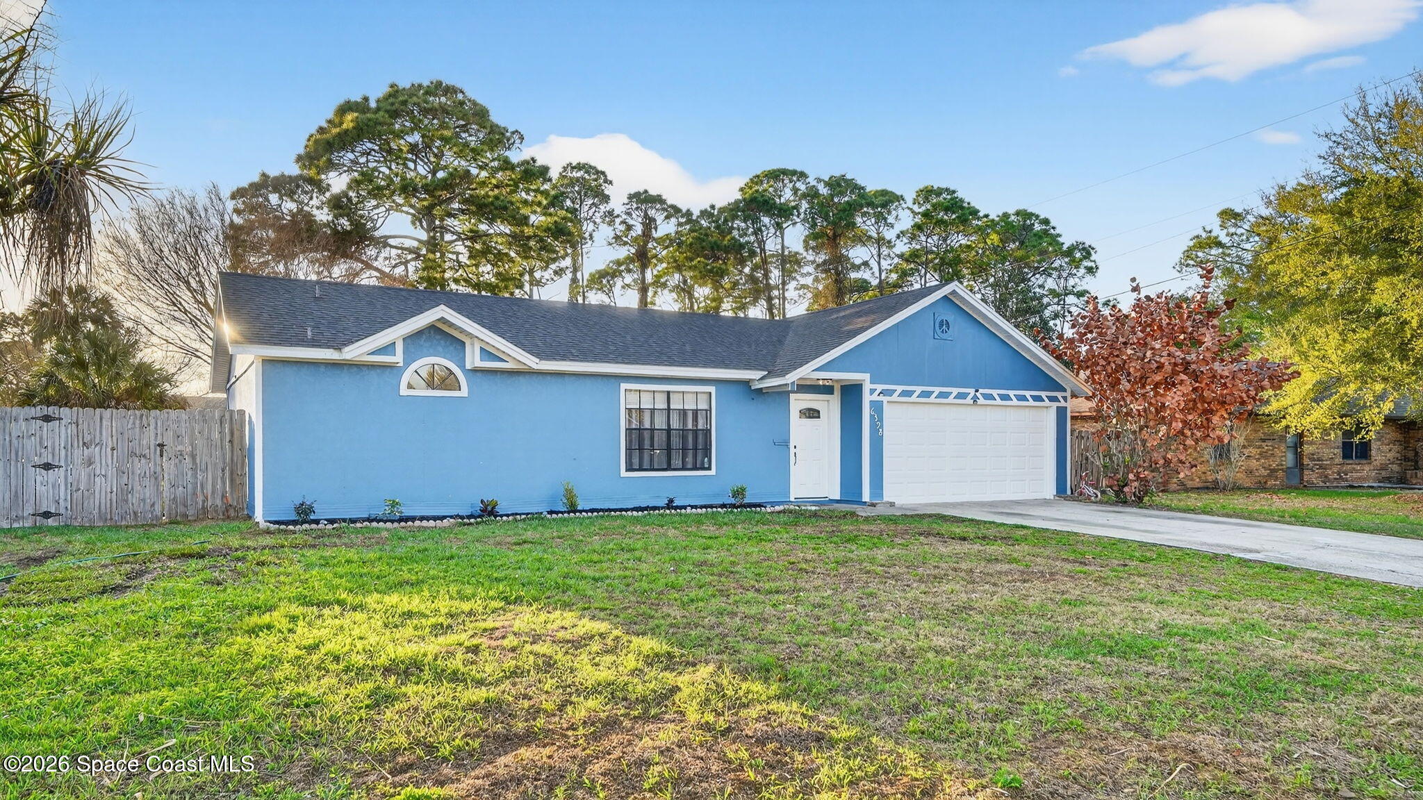 6398 Cable Avenue Cocoa, FL 32927 - Photo 2 of 30 a front view of a house with a yard and garage