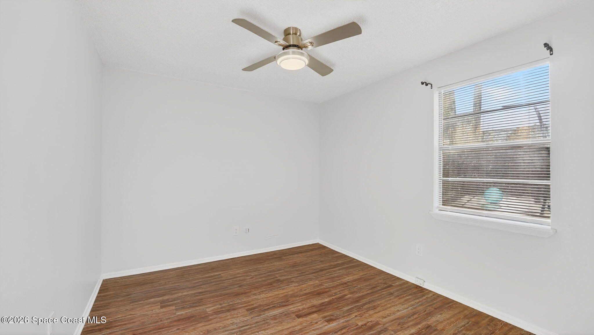 6398 Cable Avenue Cocoa, FL 32927 - Photo 21 of 30 an empty room with a window and a fan