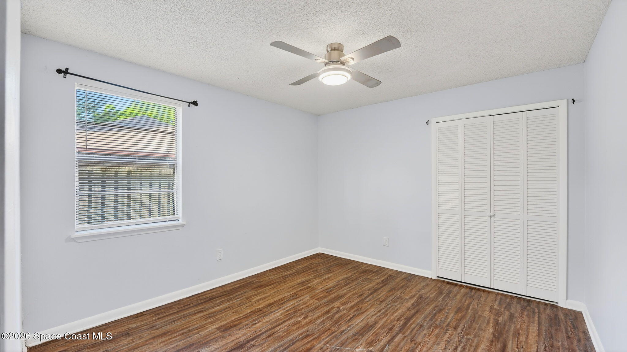 6398 Cable Avenue Cocoa, FL 32927 - Photo 22 of 30 a view of an empty room with wooden floor and a window