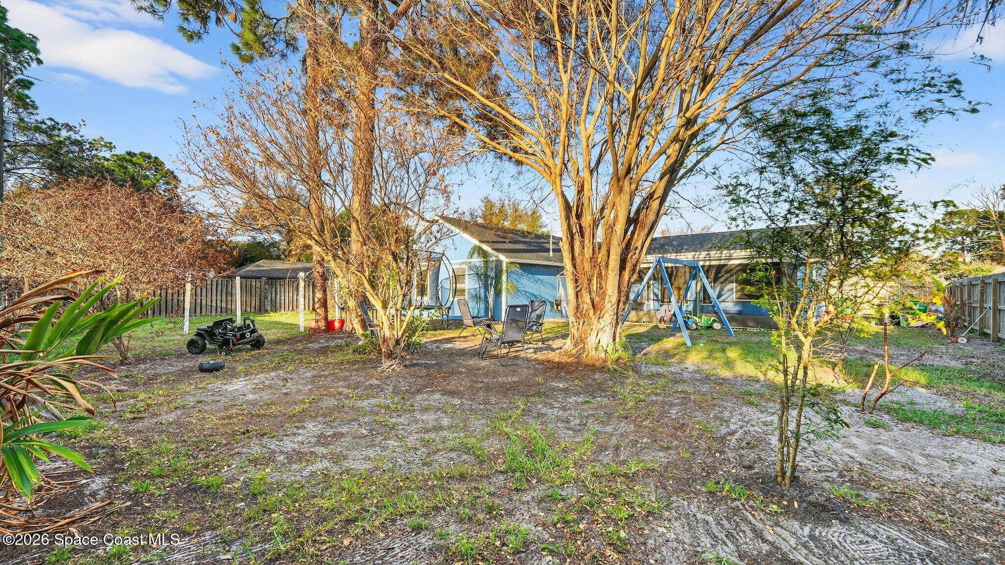 6398 Cable Avenue Cocoa, FL 32927 - Photo 27 of 30 a tree is standing in the middle of a yard