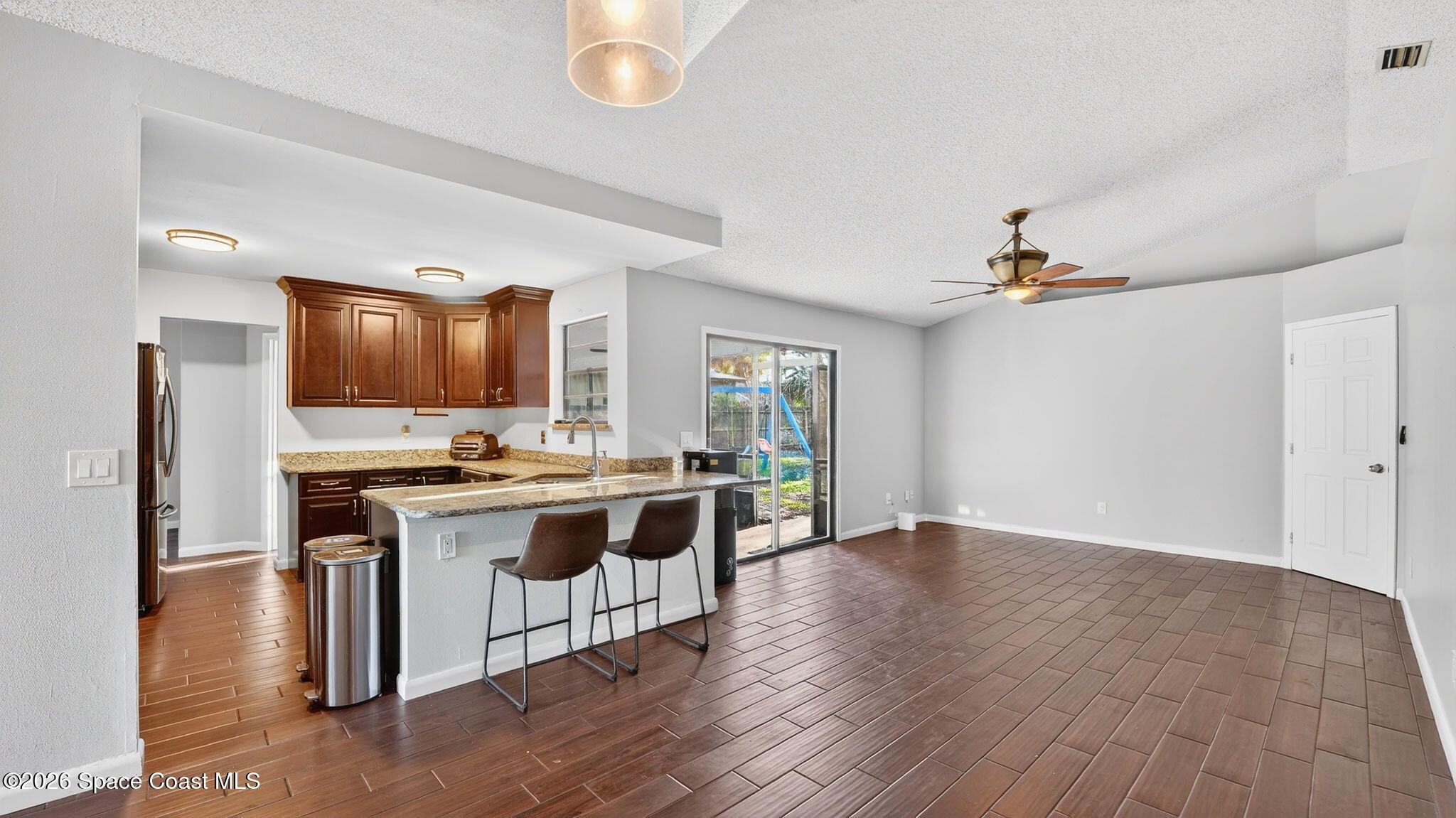 6398 Cable Avenue Cocoa, FL 32927 - Photo 8 of 30 a view of kitchen with sink microwave and stove