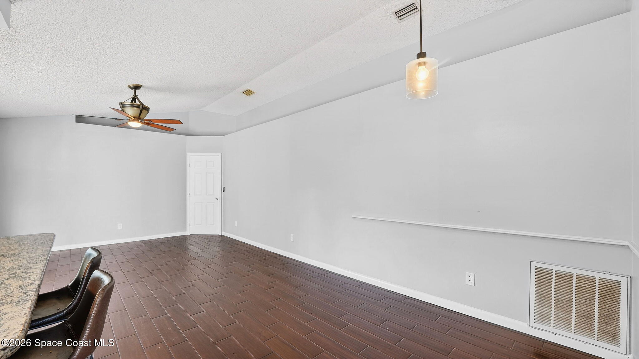 6398 Cable Avenue Cocoa, FL 32927 - Photo 9 of 30 a view of a room with wooden floor and fan