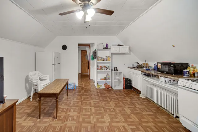 a kitchen with stainless steel appliances kitchen island granite countertop a refrigerator and microwave