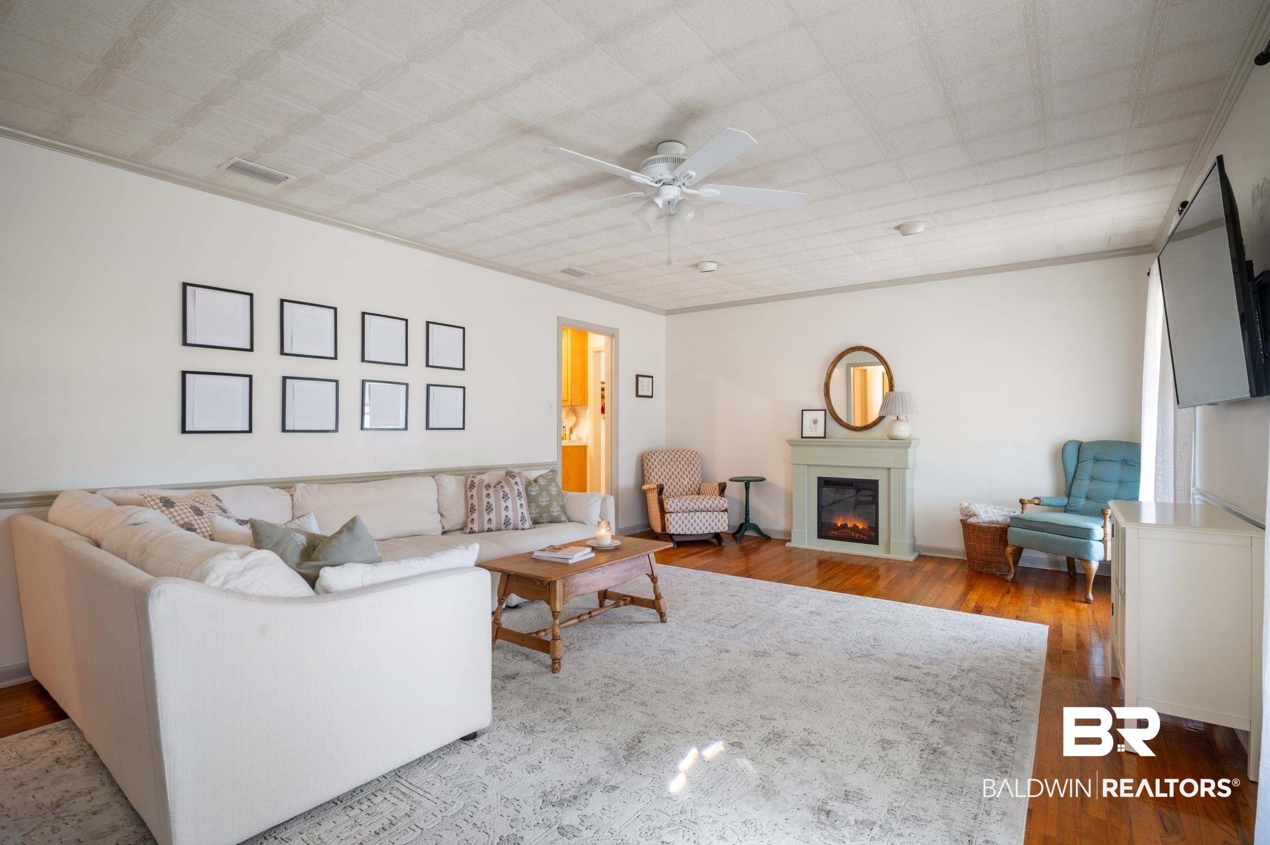 809 Moog Avenue Bay Minette, AL 36507 - Photo 17 of 33 Living room featuring wood-type flooring, ceiling fan, and a glass covered fireplace