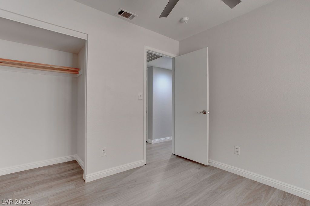 1416 Walstone Road North Las Vegas, NV 89031 - Photo 22 of 47 An inviting room features light wood flooring and a convenient open closet, ideal for modern living.
