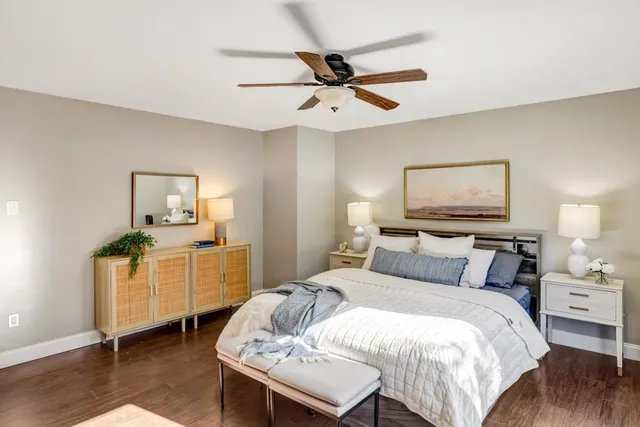 a bathroom with a granite countertop toilet a sink and a shower