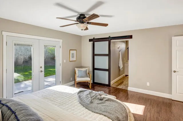 a view of a bedroom with wooden floor and a potted plant