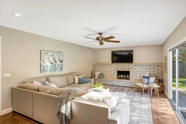 a bedroom with a bed painting on wall and a large window