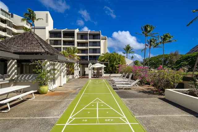 a view of a backyard with plants and a fountain