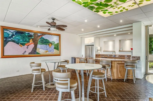 a view of a dining room with furniture a rug and wooden floor