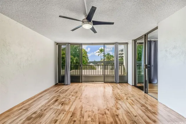 a view of a bedroom with wooden floor and balcony