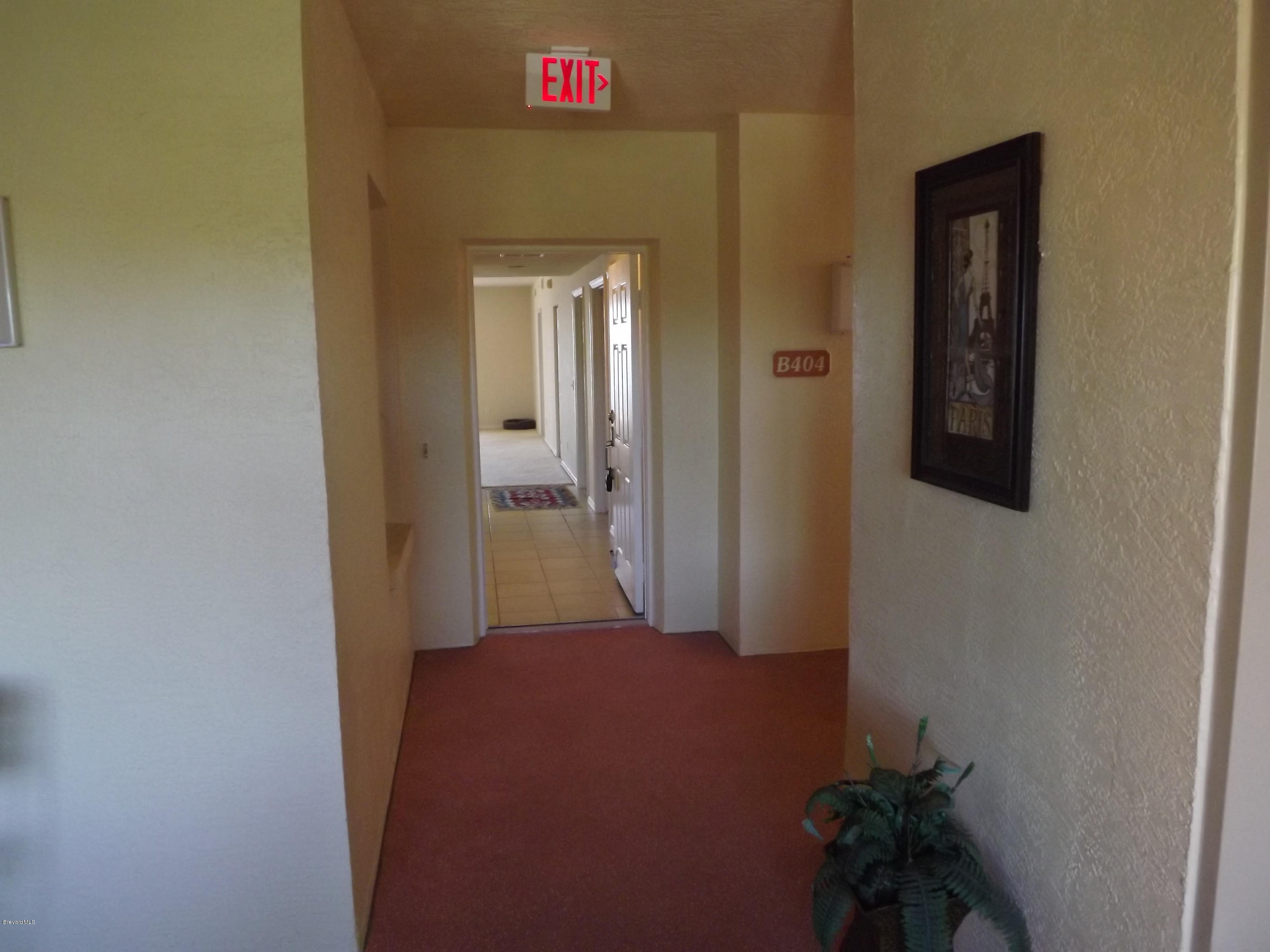 102 Riverside Drive, Unit 404 Cocoa, FL 32922 - Photo 7 of 29 Breeze Way to Front Entrance of Condo