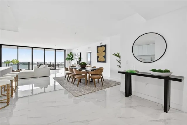 a living room with furniture a rug and a large window