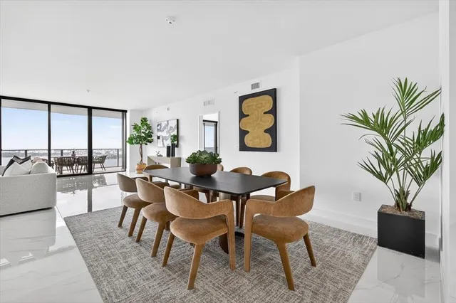 a living room with furniture potted plant and a table