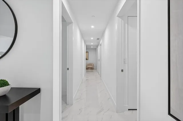 a bathroom with a toilet sink vanity and mirror