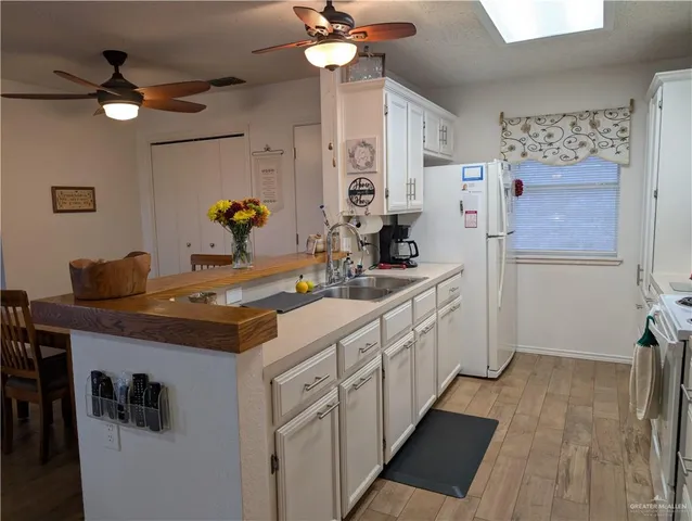 a kitchen with sink stove and refrigerator