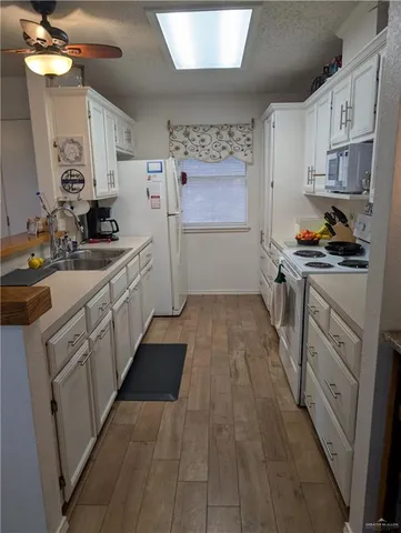 a kitchen with cabinets a sink and appliances