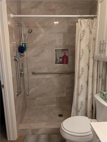 a white toilet sitting next to a bathroom sink