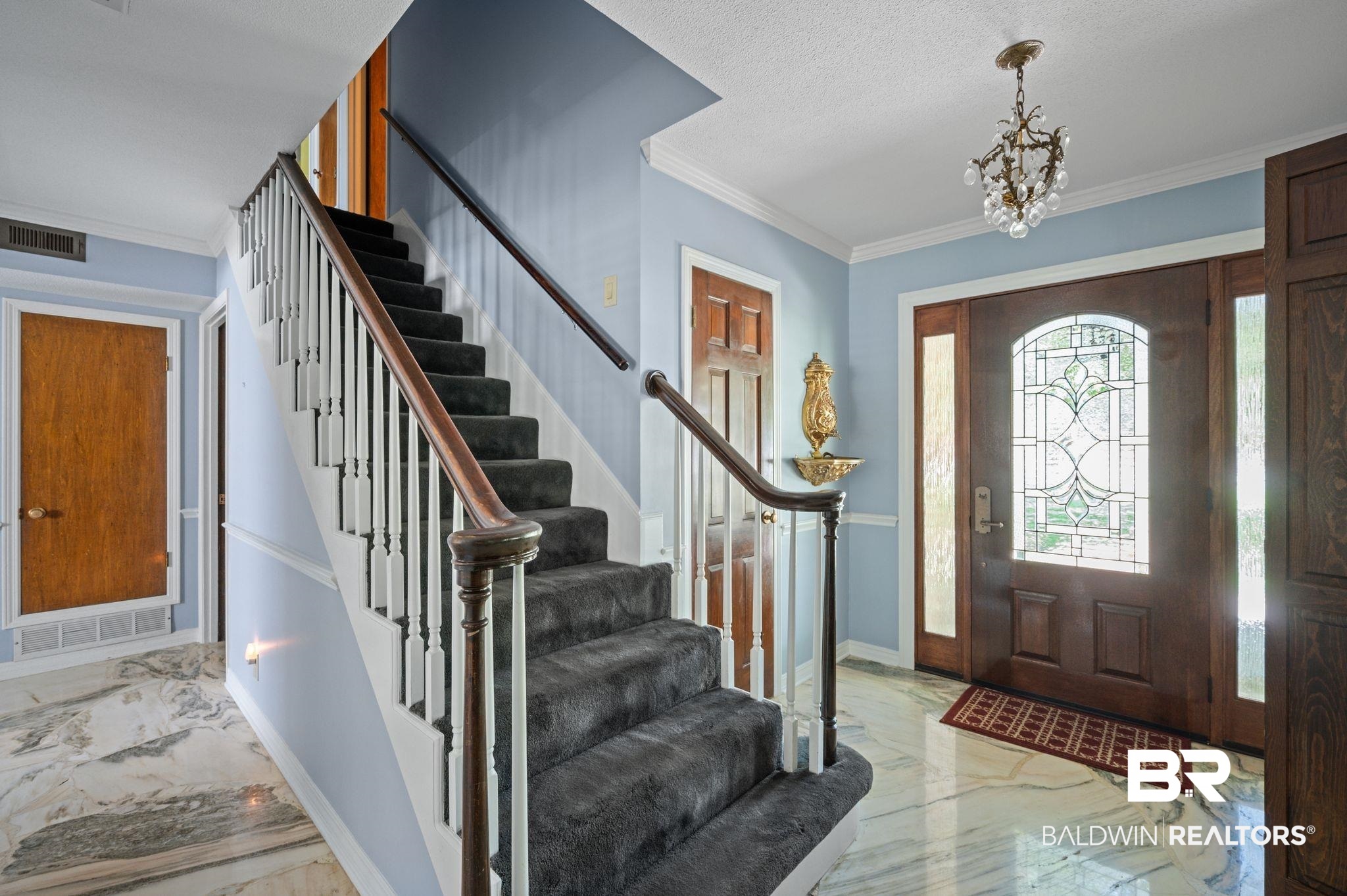 950 Walter Smith Road Mobile, AL 36695 - Photo 7 of 51 Foyer entrance with marble tiled flooring, stairway, baseboards, a chandelier, and crown molding