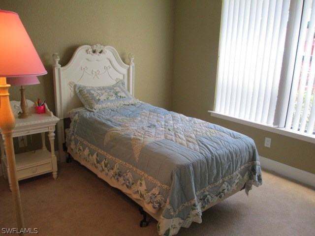 13581 Eagle Ridge Drive, Unit 1414 Fort Myers, FL 33912 - Photo 11 of 15 a bed sitting in a bedroom next to a window