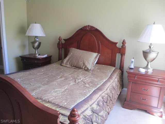 13581 Eagle Ridge Drive, Unit 1414 Fort Myers, FL 33912 - Photo 13 of 15 a bedroom with a bed and a dresser