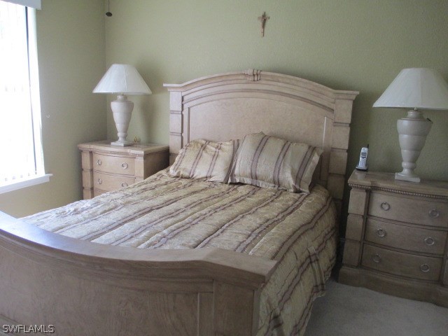 13581 Eagle Ridge Drive, Unit 1414 Fort Myers, FL 33912 - Photo 2 of 15 a bedroom with a bed and a window