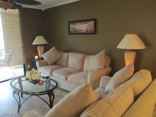 13581 Eagle Ridge Drive, Unit 1414 Fort Myers, FL 33912 - Photo 8 of 15 a living room with furniture and a lamp