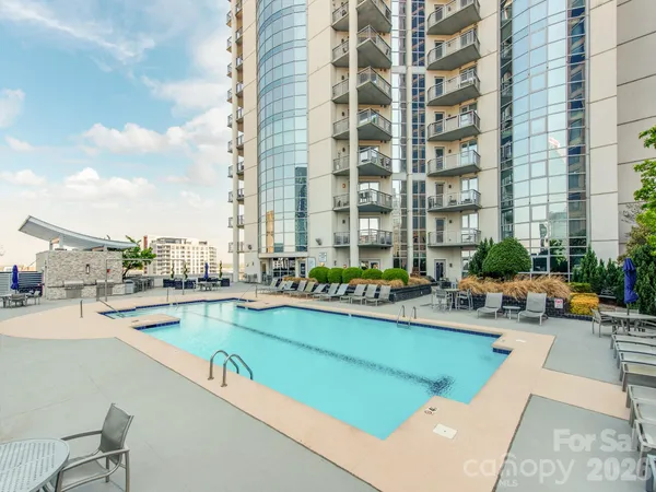 a view of swimming pool with outdoor seating