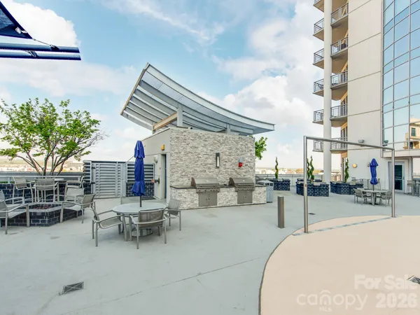 a kitchen with stainless steel appliances a stove a sink a refrigerator a table and chairs