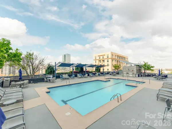 a view of a swimming pool with outdoor seating