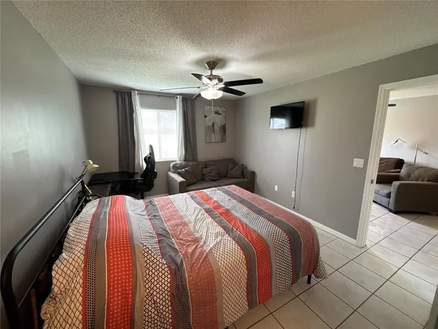 a bedroom with a large bed and a flat screen tv