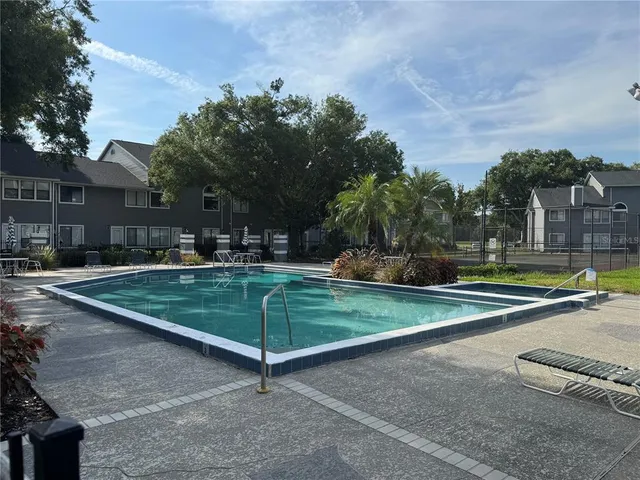 a view of a backyard with sitting area