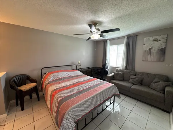 a bathroom with a granite countertop sink a large mirror and a shower